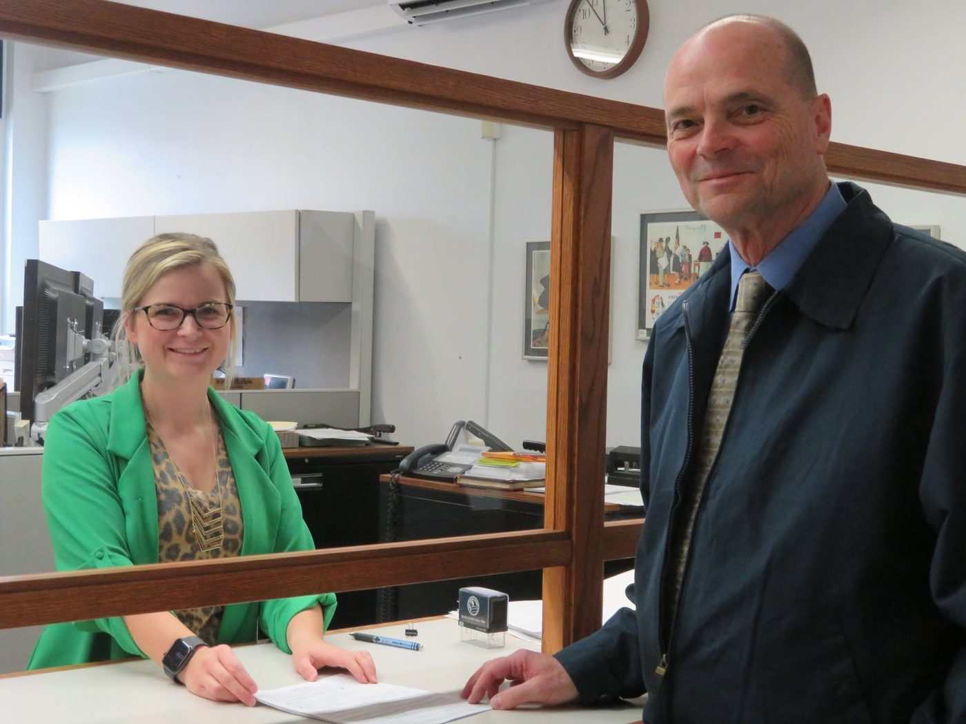 Bob Gertsen filing paperwork at a county office counter