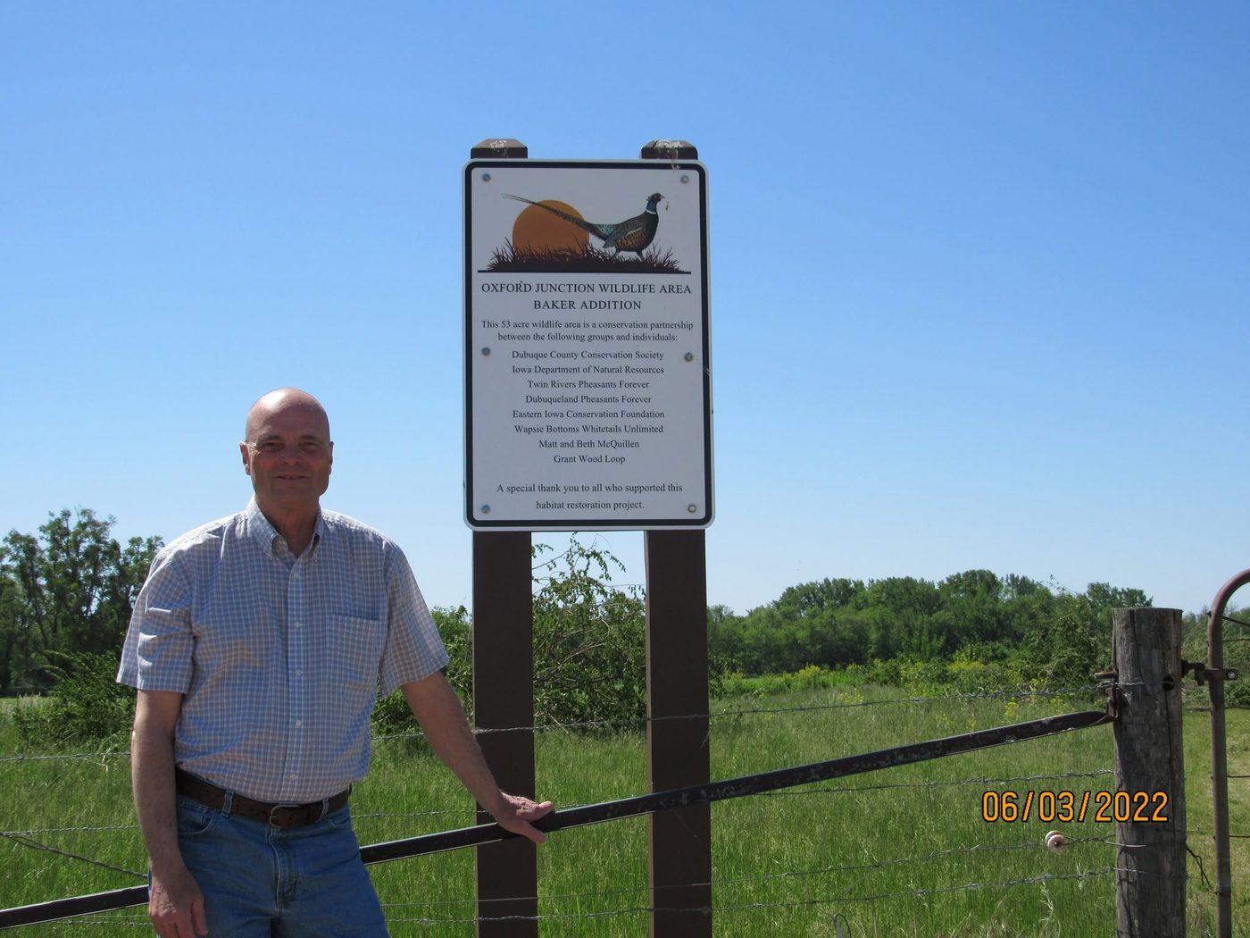 Bob Gertsen at a public land access sign in a Jones County prairie