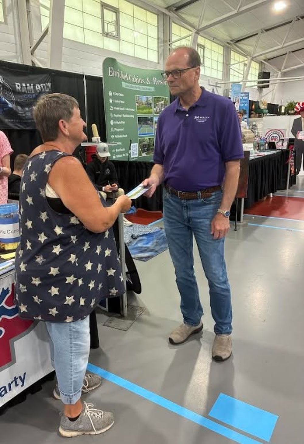 Bob Gertsen talking with a resident at an event booth
