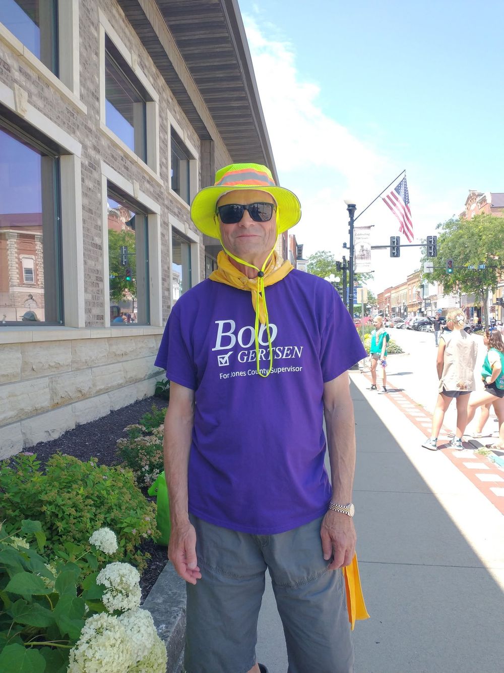 Bob Gertsen in a campaign shirt and sun hat at a small-town parade
