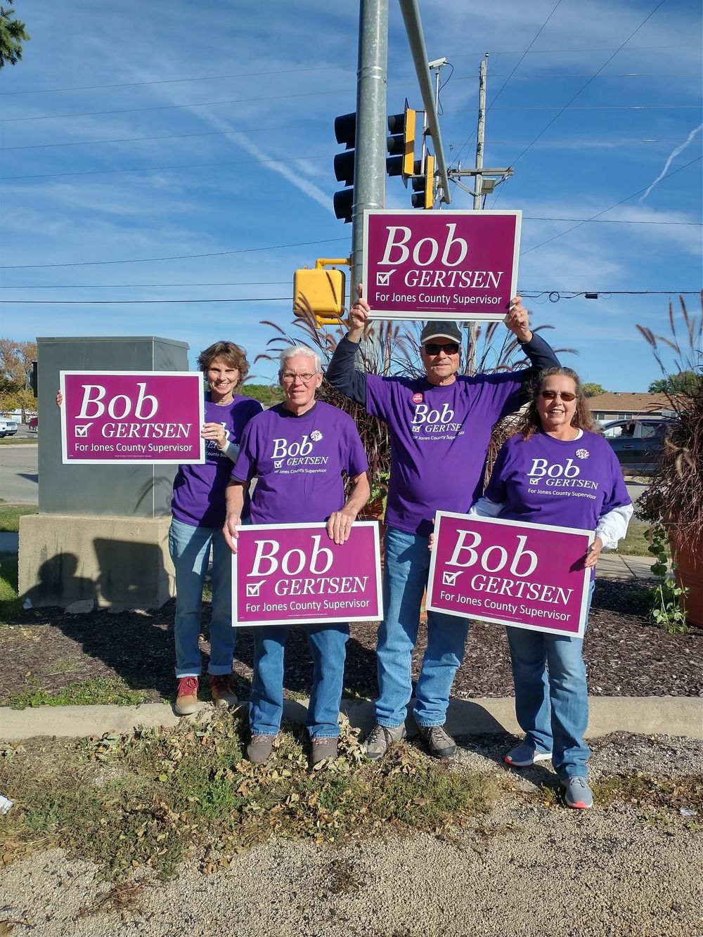 Volunteers holding Bob Gertsen signs along a Jones County road